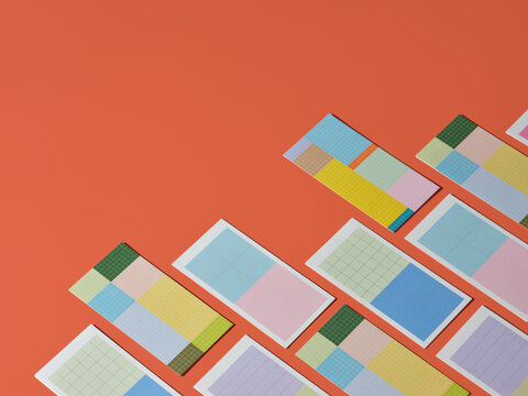 Colorful geometric notepads arranged on a vibrant orange background