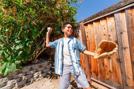happy kid playing throwing baseball