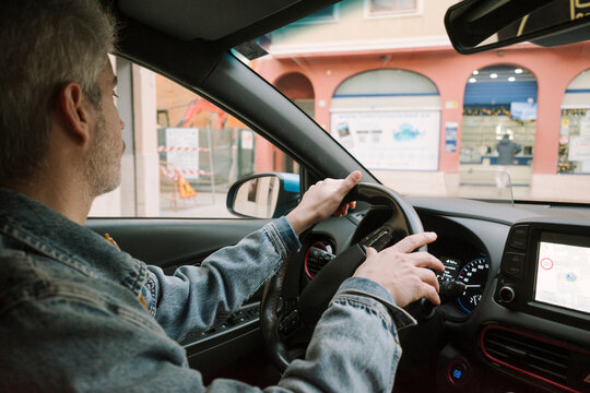 Man Driving Through City