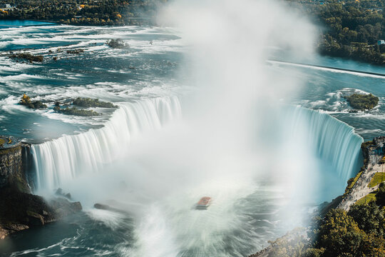 Niagara Falls waterfall cascading over rocky cliff edge with powerful flowing water motion