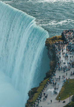 Niagara Falls waterfall cascading over rocky cliff edge with powerful flowing water motion