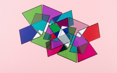 Obraz premium Overlapping Translucent Colorful Geometric Shapes on Light Pink Background, Studio Still Life Shot