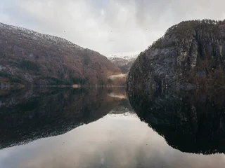 Scenic view of Norwegian fjord with mountain reflection in calm water © Olga
