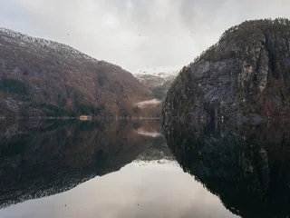 Scenic view of Norwegian fjord with mountain reflection in calm water © Olga