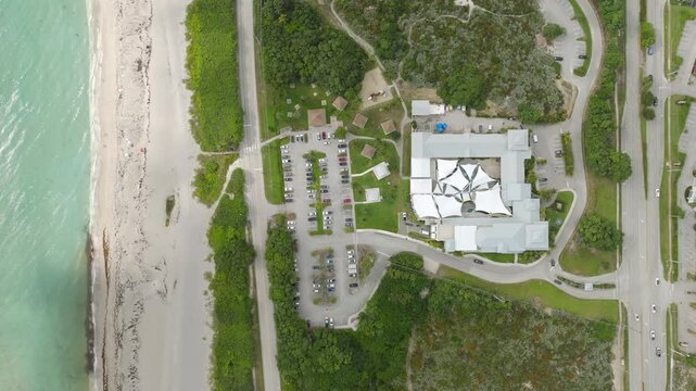 Aerial View of Juno Beach Florida Shoreline With Turquoise Ocean, Sand and Beach Umbrellas