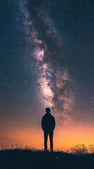 Fototapeta premium Silhouette of a person standing under the milky way galaxy