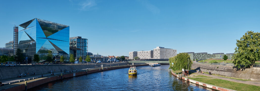 Berlin, Germany, August 13, 2026, panoramic view of the Spree River, featuring Spreebogenpark, the Berlin Cube, the PWC building, and the Central Station