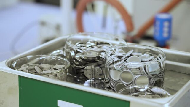 Battery material samples undergoing laboratory quality and purity testing in an ultrasonic bath as part of battery research, material analysis and industrial production control.