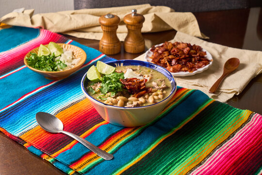Traditional mexican carne en su jugo with white beans, cilantro, lime, and bacon