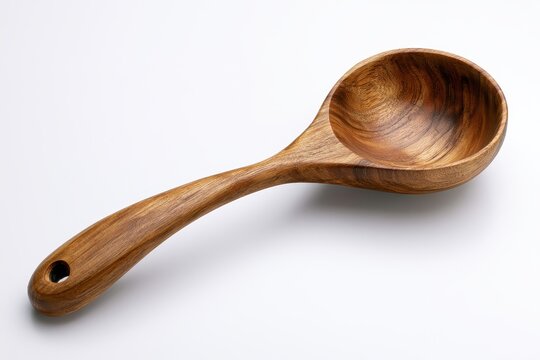 A wooden ladle with a curved handle and a deep bowl, crafted from natural timber, isolated on white background