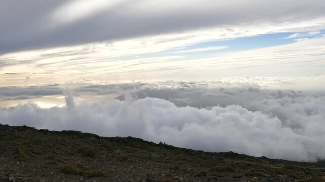 Sunset view above the clouds from Kalahaku Overlook in Haleakalā National Park, on the Haleakala volcano on the island of Maui, Hawaii. Looking west. Also known as the East Maui Volcano.