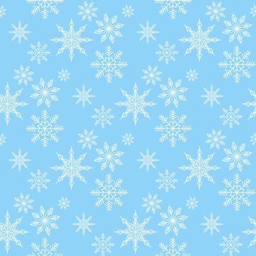Seamless blue winter pattern with hand-drawn white snowflakes and delicate crystal foliage illustration texture background