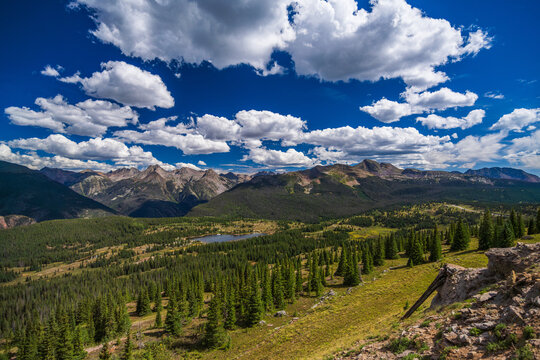Mountain valley with forest lake and summer tundra