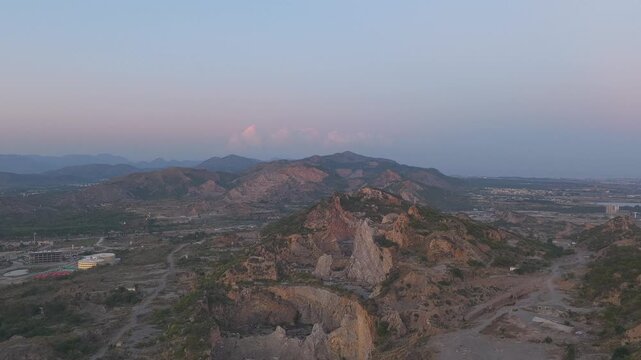Panoramic aerial view of Margalla mountain ridge between Faisal Hills and B-17 Multi Gardens at sunset