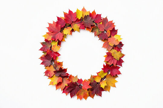 Autumn wreath made of colorful maple leaves isolated on white background