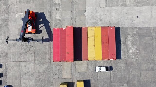 Container Terminal Operations at Port with Heavy Reach Stacker Moving Cargo Containers. Aerial View of Container Terminal with Reach Stacker Moving Shipping Containers
