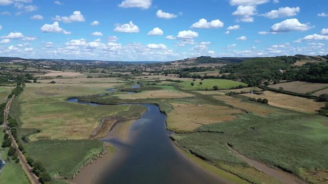 River Axe, Devon, England: DRONE VIEWS: 1. The River Axe valley; 2. Seaton tramway track (left of picture). The Axe joins the Jurassic Coast at the town of Seaton from which the tramway runs.