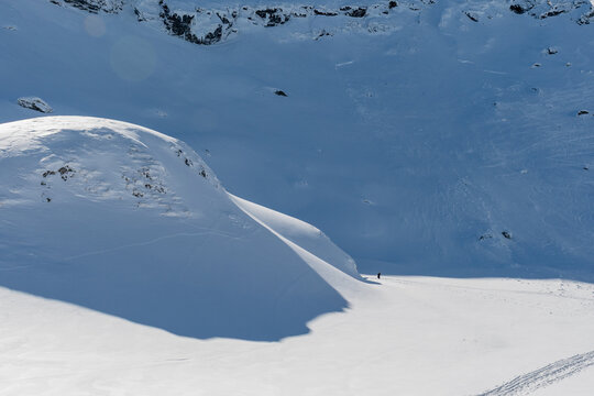 Pristine snow-covered mountain slope with dramatic shadows in the Balea area of the Romanian Carpathians.