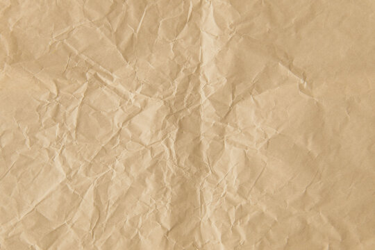 Crumpled brown paper texture with visible creases and folds.