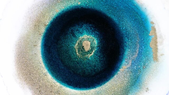 Mixing alcohol ink creates abstract patterns on a surface