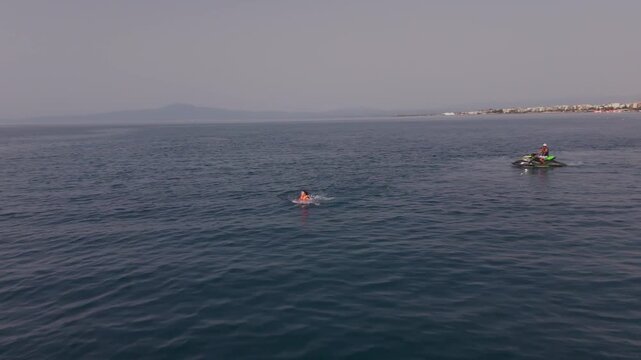 Woman Moving at the Sea Surface During a Flyboarding Session off Kalamata Beach, Greece, Drone View

