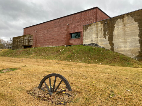 Corinth, Mississippi: Corinth Civil War Interpretive Center. Bronzed wagon wheel among "Detritus of War" along path to visitor center entrance. 