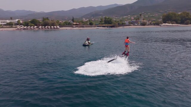 Woman Taking Off on a Flyboard, Losing Balance and Falling into the Sea off Kalamata, Greece, Drone View
