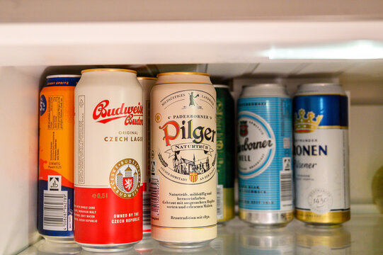 Iserlohn, Germany - August 15, 2026: Multiple beer and beverage cans are neatly arranged on a shelf inside a refrigerator