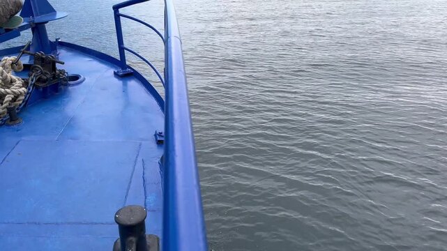 Slow motion of girl looking at waves from a ferry boat bow