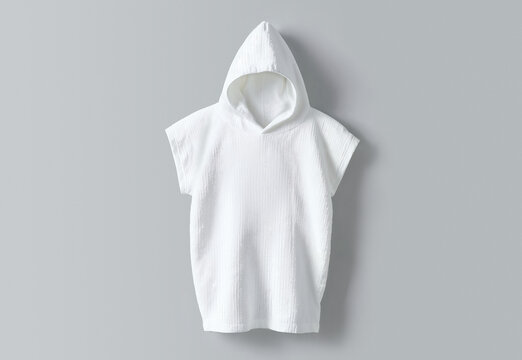 White baby hooded towel poncho on grey background, ai generated. Soft absorbent bath towel with hood and open sides for infant and toddler bathing, swimming, beach and after-bath concept.