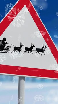 Snowflakes falling against santa claus in sleigh being pulled by reindeers on stop sign