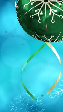 Animation of snow falling over christmas bauble decorations on blue background