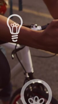 Animation of light bulb icons and data processing over caucasian man using smartphone