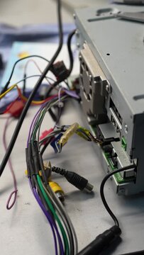 Car radio head unit rear panel with connected wiring harness.