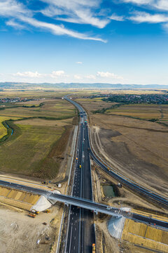Aerial view of the new Autostrada A7 highway and junction near Bacau under bright daylight, highlighting modern infrastructure, road construction, and transportation. Moldova Highway in Romania