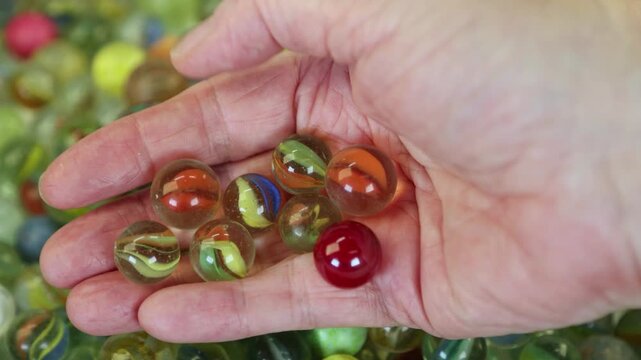 Hand hold beautiful toy glass marbles