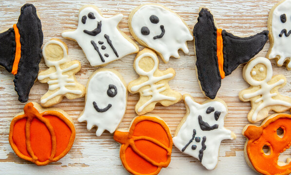 Halloween gingerbread cookies, Top view of spooky Halloween cookies in a bucket with autumn leaves