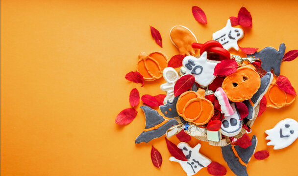 Halloween gingerbread cookies, Top view of spooky Halloween cookies in a bucket with autumn leaves
