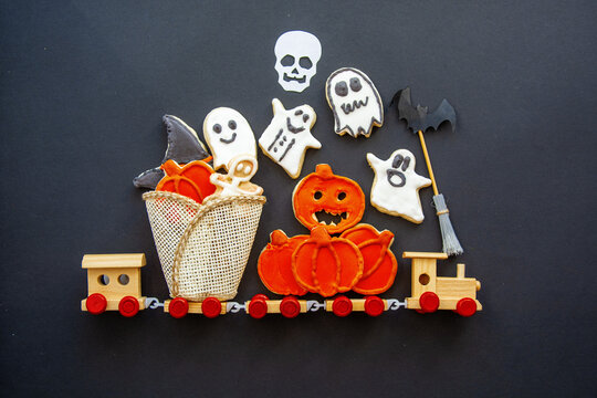 Halloween gingerbread cookies, Top view of spooky Halloween cookies in a bucket with autumn leaves