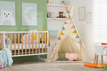 Cute baby room interior with comfortable crib, wigwam and other toys © New Africa