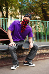 Stylish man with skateboard in skate park © New Africa