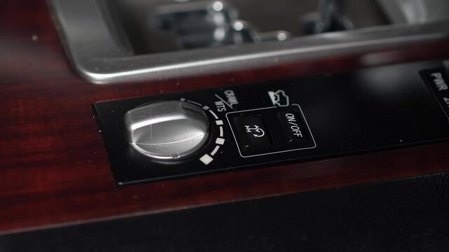Car center console off-road control panel featuring a Crawl Control and Multi-Terrain Select (MTS) selector knob on a wooden trim background.