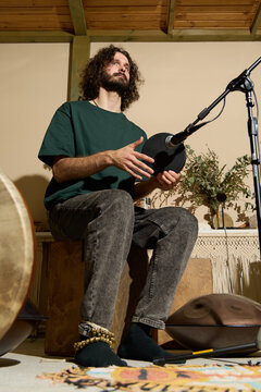 Intimate session of musician performing with cajon and warm light