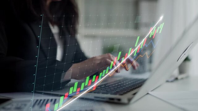 A professional businesswoman engages with data and stock market graphs on her laptop, showcasing modern finance practices in a contemporary office setting. Copula