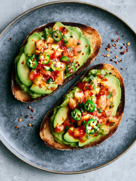 avocado toast with pico de gallo, diced jalapenos, chili flakes and hot sauce.