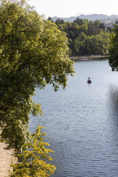 high angle view of swan-shaped boat cruising on the T&acirc;mega River of the town of Amarante, Portugal on a clear day