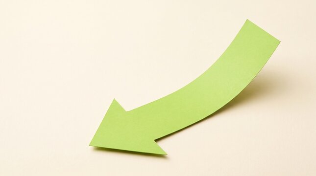 Green paper arrow pointing down on a light background for business growth and trend concepts