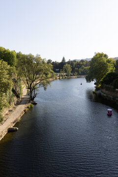 high angle view small boats sailing on the T&acirc;mega River of the town of Amarante, Portugal on a clear day