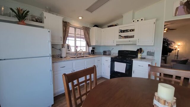 Bright kitchen with round wooden dining table