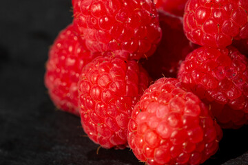 Fresh appetizing ripe raspberries in a detailed macro shot showing texture and vibrant red color © Vlad Ispas